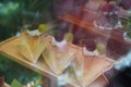 three cherries on cream and green grapes on cake, on a wooden tray, in a glass cabinet, sweet, food, dessert, decor, fashion, copy Royalty Free Stock Photo