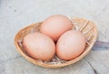 Three chicken eggs in bamboo basket Royalty Free Stock Photo