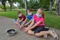 Three children begging in the city wearing protective masks from the virus. Social problems during the covid-19 coronavirus Royalty Free Stock Photo