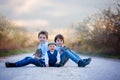 Three children, boy brothers in park, playing with little bunnies Royalty Free Stock Photo