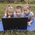 Three children are carefully studying