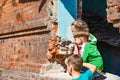 Three children in a destroyed house are hiding from military conflicts, refugee children have suffered from the destruction of