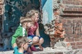 Three children in a destroyed house are hiding from military con