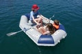 Three children in an inflatable dinghy Royalty Free Stock Photo