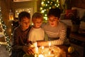 Three children, lighting candles in a nutshell, czech Christmas traditions