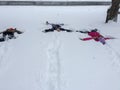 Three Kids Making Snow Angels