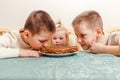 Three children and plate of pancakes for the carnival. kids eat pancakes at home at the table Royalty Free Stock Photo