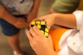 Children playing colorful rubik`s cube