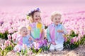 Three children playing in beautiful hyacinth flower field. Royalty Free Stock Photo