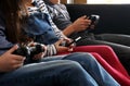 Three children playing with electronic devices - tablet, smartphone and games controller Royalty Free Stock Photo