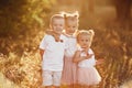 Three children playing in the field in summer. young children playing outdoors smiling. happy family. carefree childhood Royalty Free Stock Photo