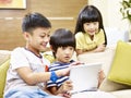 Three children playing video game using digital tablet Royalty Free Stock Photo