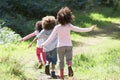 Three Children Playing In Woods Together