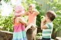 Three children of same age show different emotions. Kids in green garden play game deaf blind dumb outdoors in summer