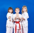 Three children standing in karate rack and showing finger super