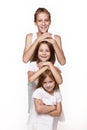 Three children in the studio on a white background, a brother and two sisters laugh Royalty Free Stock Photo