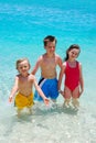 Three Children Wading In Ocean