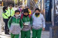 three children walk to the entrance of the school happy Royalty Free Stock Photo