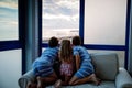 Three children watching sunrise on terrace or balcony. Two kids boys and preschool girl watch sun on horizon. Happy children Royalty Free Stock Photo