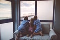 Three children watching sunrise on terrace or balcony. Two kids boys and preschool girl watch sun on horizon. Happy Royalty Free Stock Photo