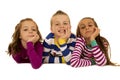 Three children wearing christmas pajamas with their chin on hands Royalty Free Stock Photo