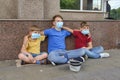 Three children wearing protective masks ask for alms during the Sovid 19 pandemic Royalty Free Stock Photo