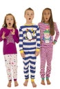 Three children wearing winter pajamas with a startled facial exp