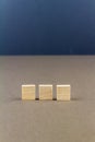 Three children wooden blocks in line, portrait