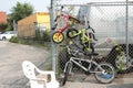 three childrens kids bikes bicycles locked to silver diamond fence high and low. p