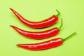 Three chilies on a green background