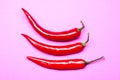 Three chilies on a violet pastel background