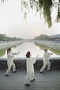 Three Chinese People Practicing Tai Ji