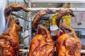 Three Chinese Style Roast Ducks hanging from a shop window