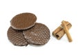 Three chocolate biscuits and cinnamon sticks isolated Royalty Free Stock Photo