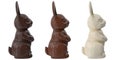 Three chocolate bunnies made from black, milk and white chocolate, isolated on white.