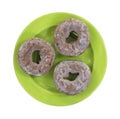 Three chocolate donuts on green plate Royalty Free Stock Photo