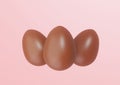 Three Chocolate Easter Eggs on pink background Royalty Free Stock Photo