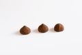 Three chocolate truffles whit chocolate powder on white background. Royalty Free Stock Photo