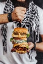 Three choices of tasty homemade burger with knife. Healthy falafel burger with fresh lettuce, savory grilled chicken with fresh cu Royalty Free Stock Photo