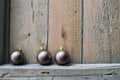 Three Christmas balls on old wooden background wall. Royalty Free Stock Photo