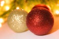 Three Christmas balls. Festive decoration on bokeh background. Royalty Free Stock Photo