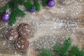 Three Christmas cakes, winter snowbound wooden background, purple ball ornament