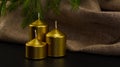 Three Christmas candles of different sizes stand in a piece with unlit wicks against a background of linen canvas A