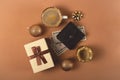 Three Christmas gift boxes on a neutral background among decorations