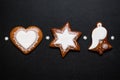 Three Christmas gingerbread cookies on black background Royalty Free Stock Photo