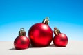 Three Christmas glass balls on the beach Royalty Free Stock Photo