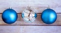 Three Christmas shiny balls on white wooden background Royalty Free Stock Photo