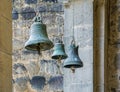 Three church bells of small, medium and large size hanging in chains Royalty Free Stock Photo