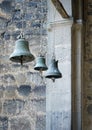 Three church bells of small, medium and large size hanging in chains Royalty Free Stock Photo