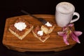 Three Churro Cheesecake pieces, one fork, one flower and a drink on a wooden base Royalty Free Stock Photo